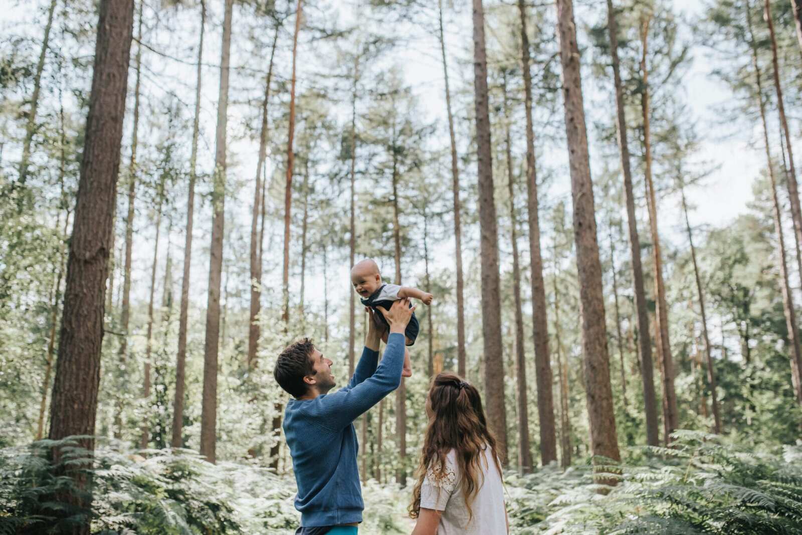 Young family playing in woods in Stamford